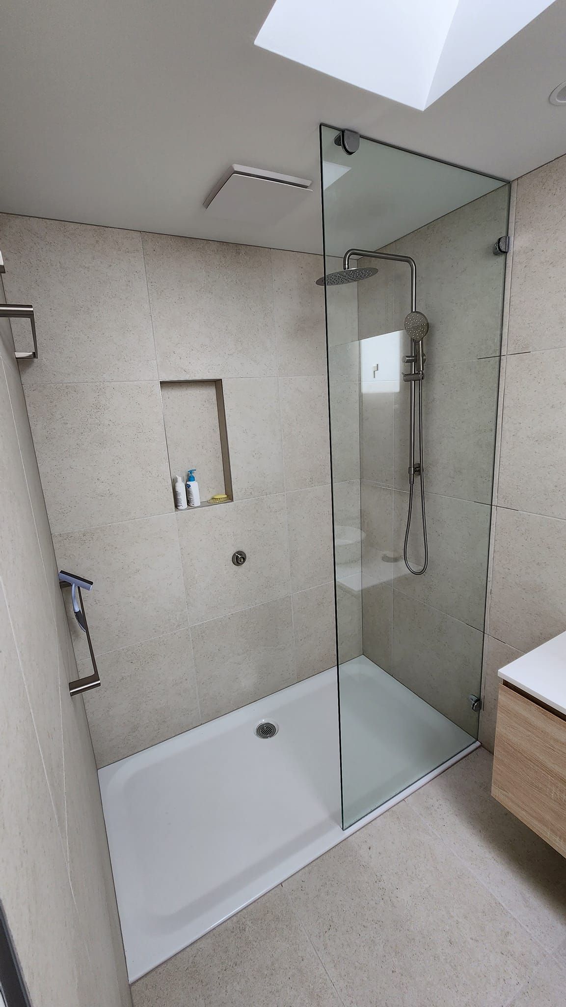 A bathroom with a walk in shower and a bathtub.