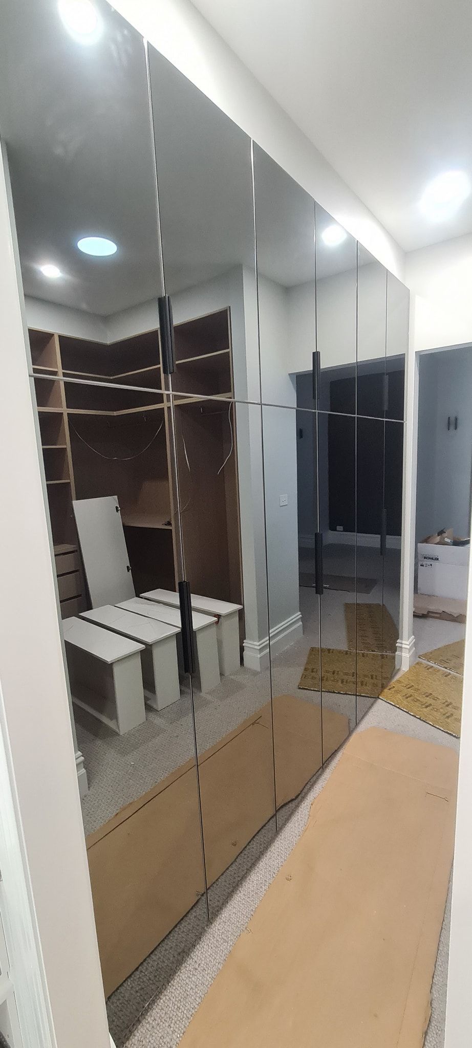 A large mirror is being installed in a room.