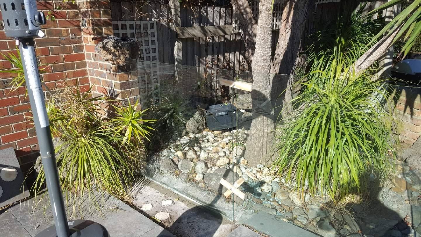 A patio with a heater and a brick wall in the background.