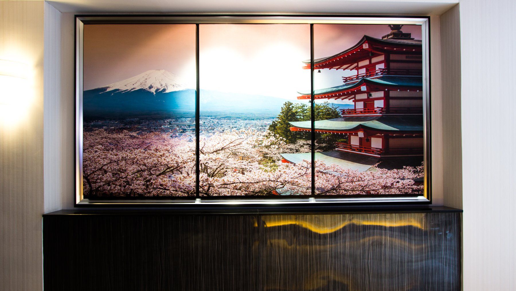 Triptych of Japanese landscape: Mount Fuji, cherry blossoms, and a red temple.