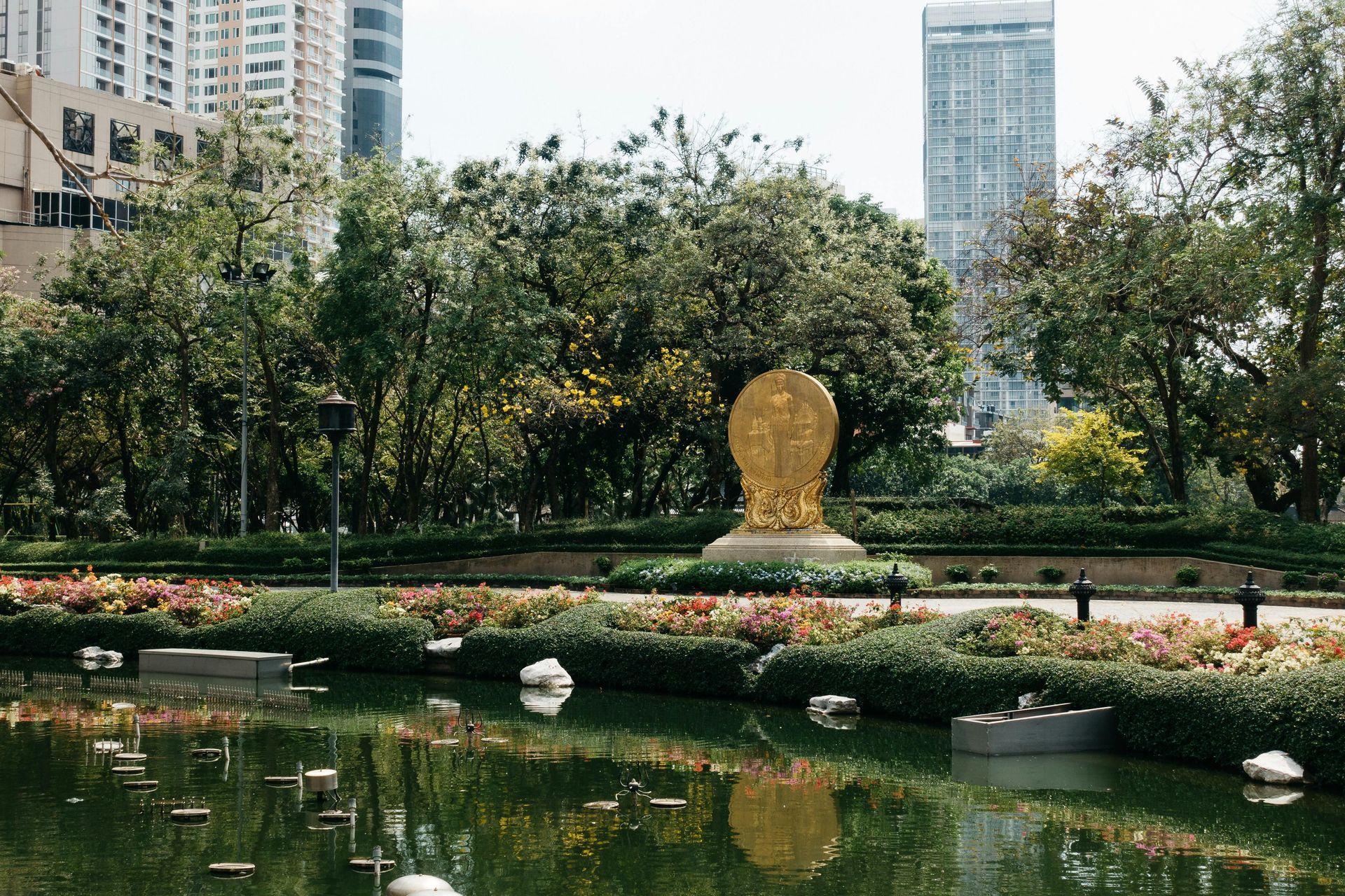 A woman is flying a kite in the ocean.