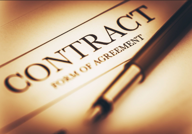 a pen rests on top of a contract form