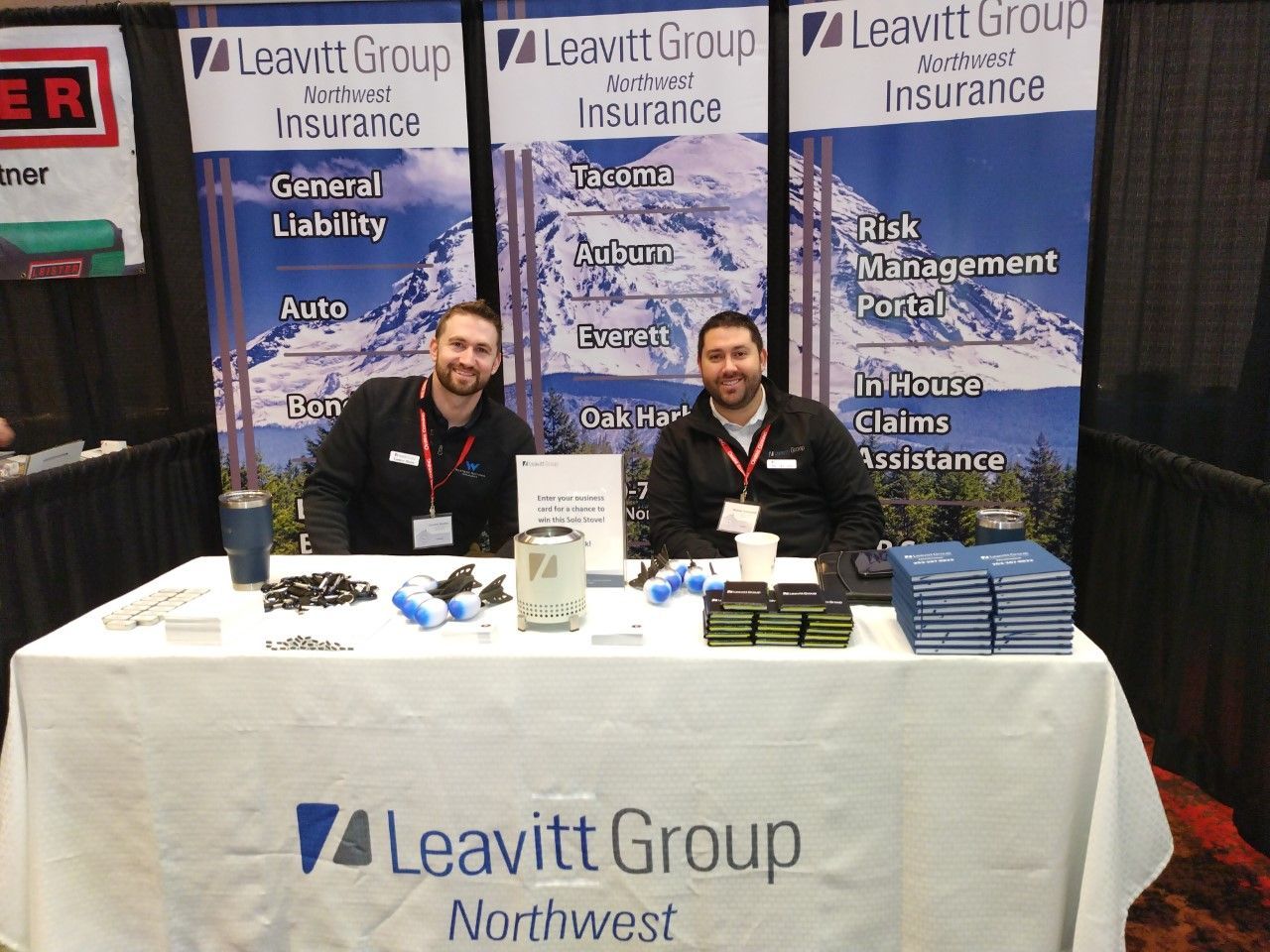 two men sitting at a leavitt group northwest table