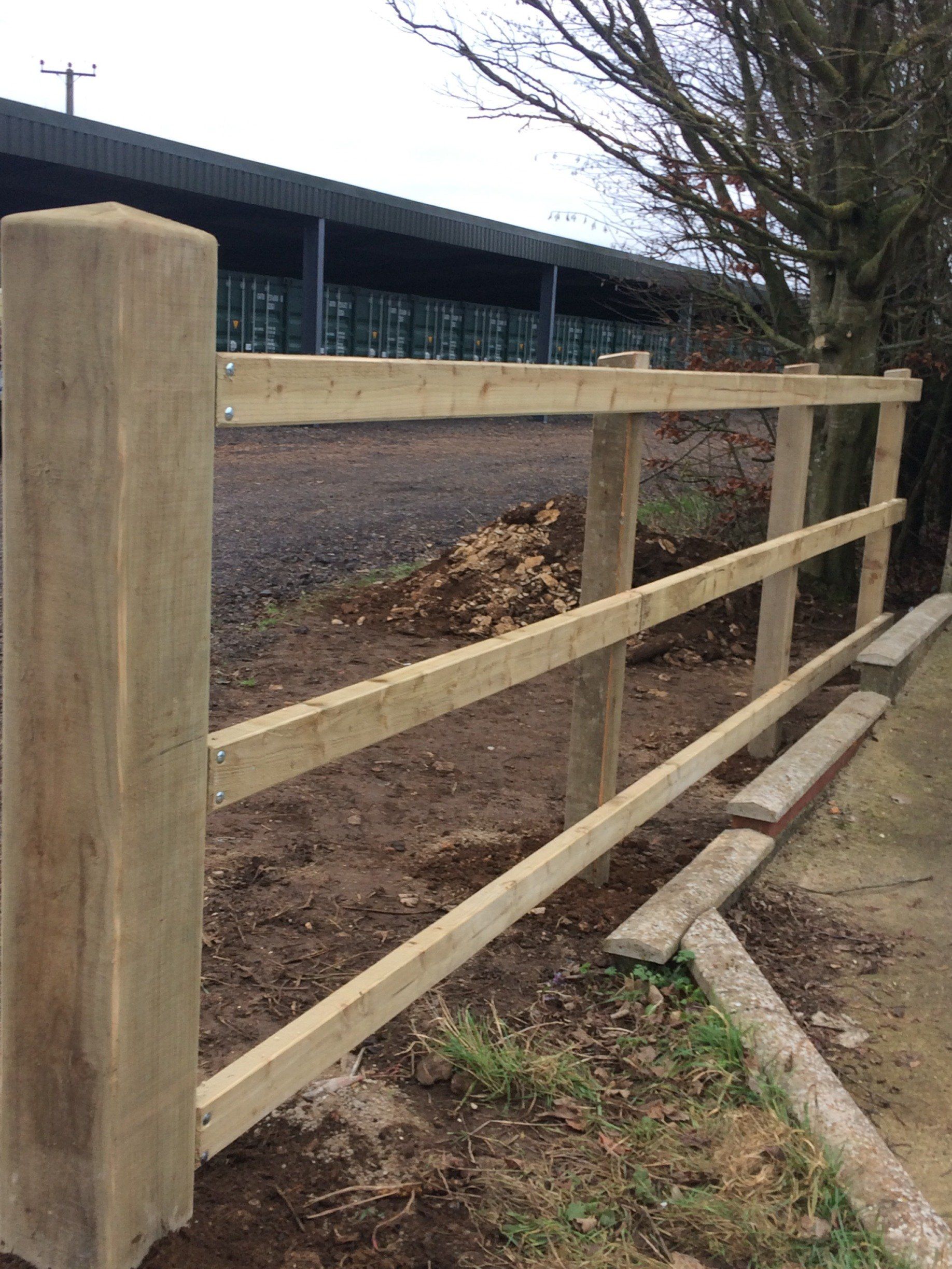 A wooden fence is being built in front of a building.