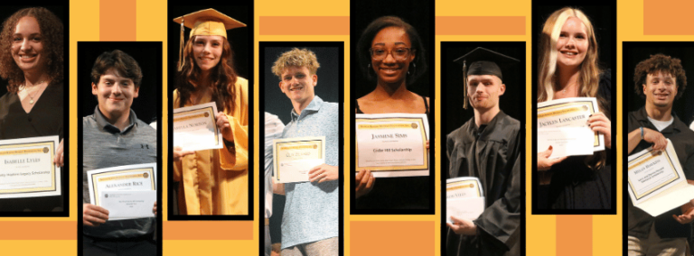 A group of people in graduation caps and gowns are holding certificates.