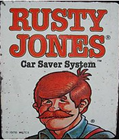 A rusty jones car saver system sign with a man with red hair and a mustache.