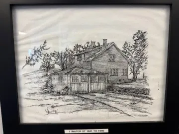 A black and white drawing of a house with trees in the background.