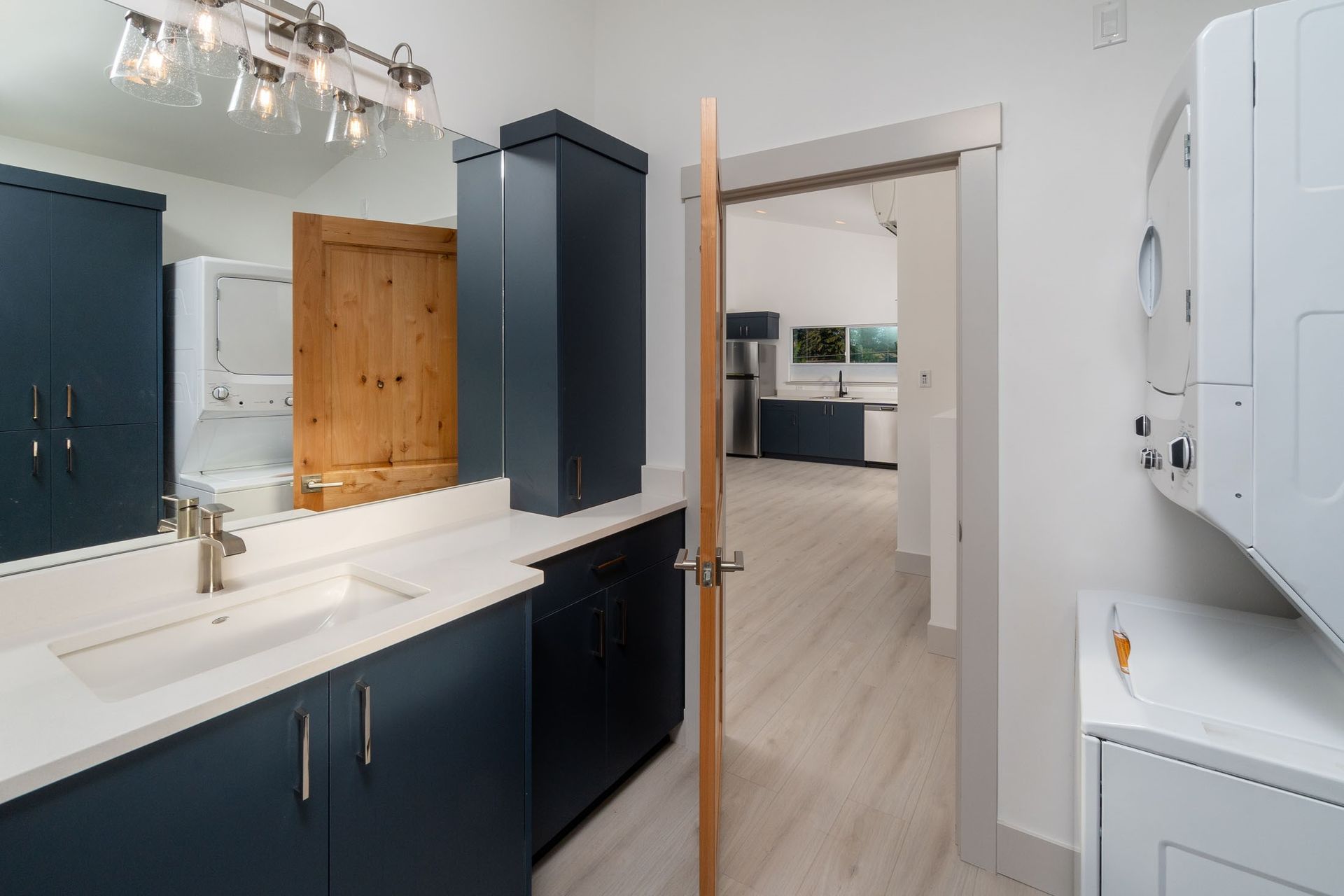 A bathroom with a sink and a washer and dryer