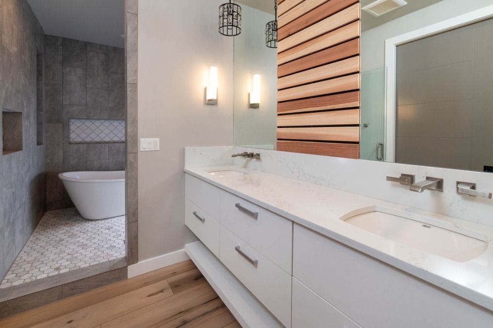 A bathroom with two sinks and a large mirror