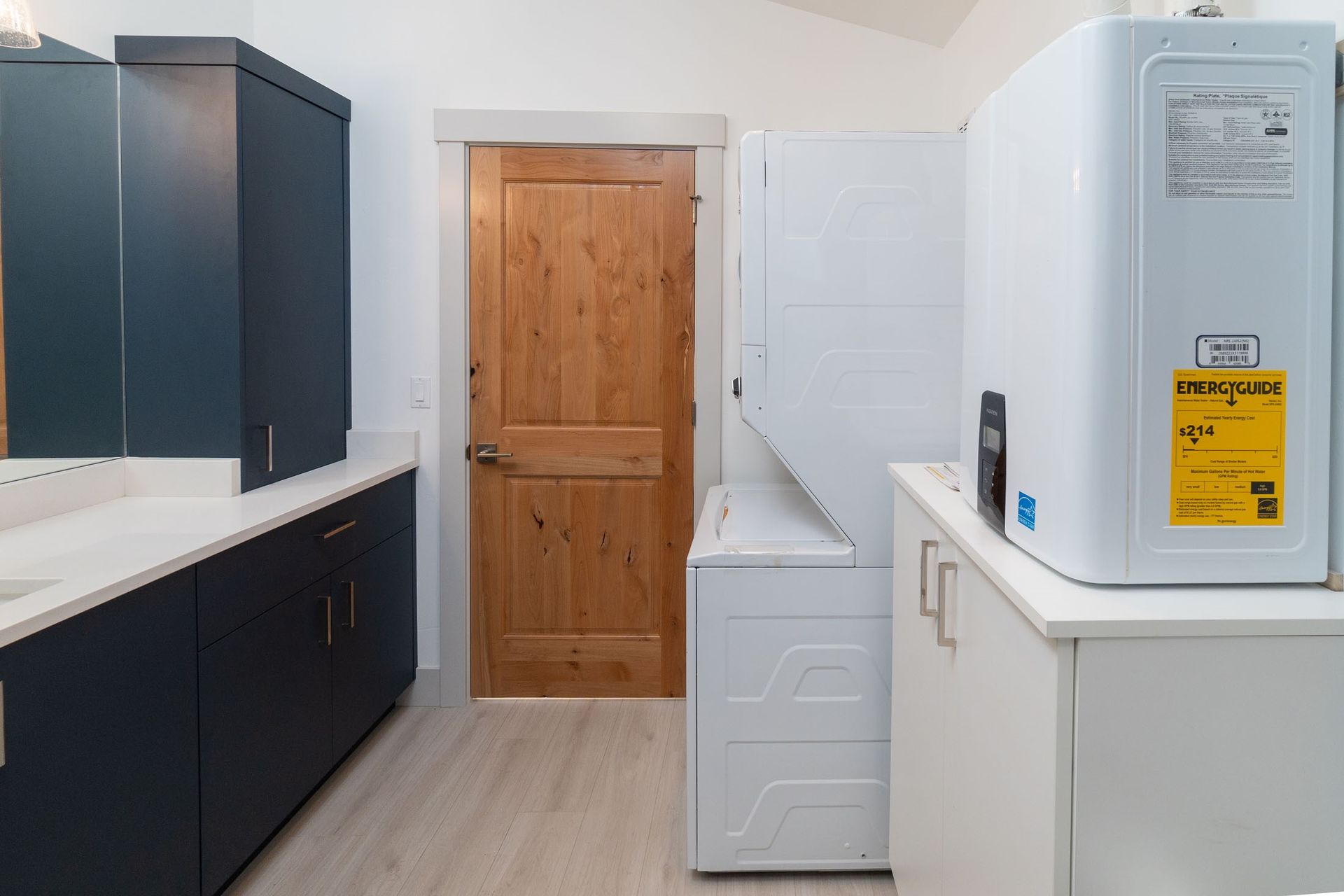 A laundry room with a washer and dryer and a sink.