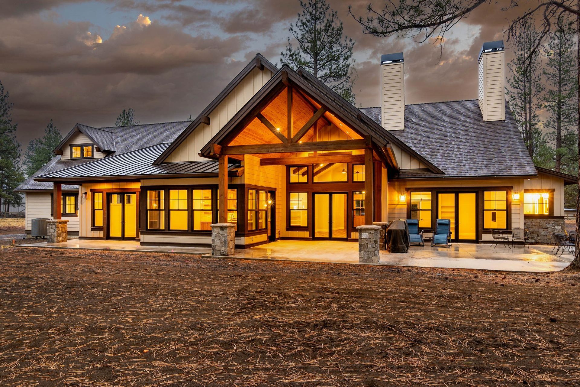 A large house with a lot of windows is lit up at night