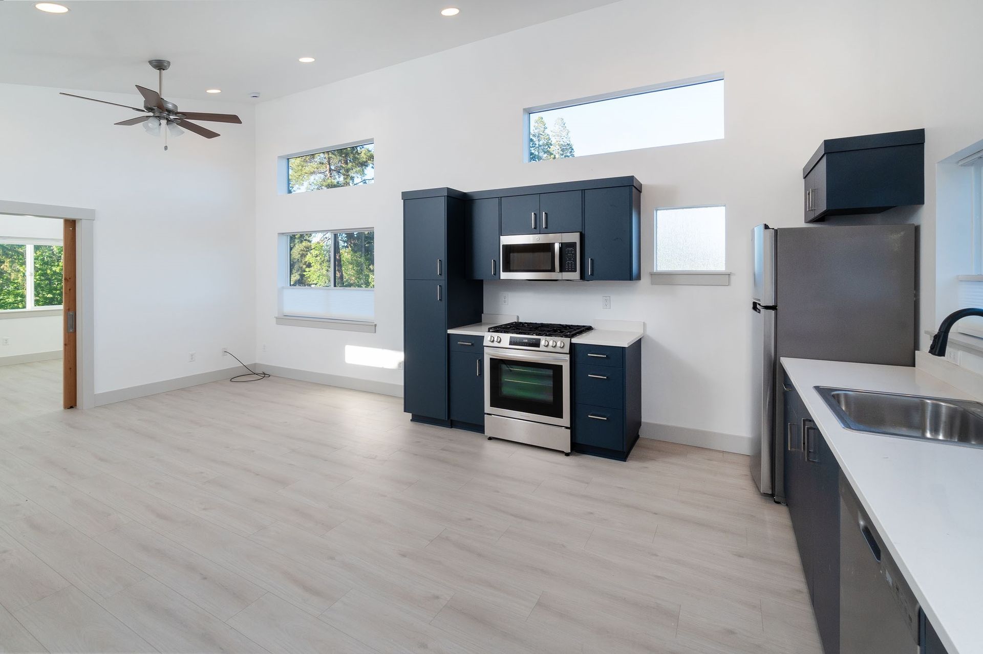 A kitchen with stainless steel appliances and blue cabinets