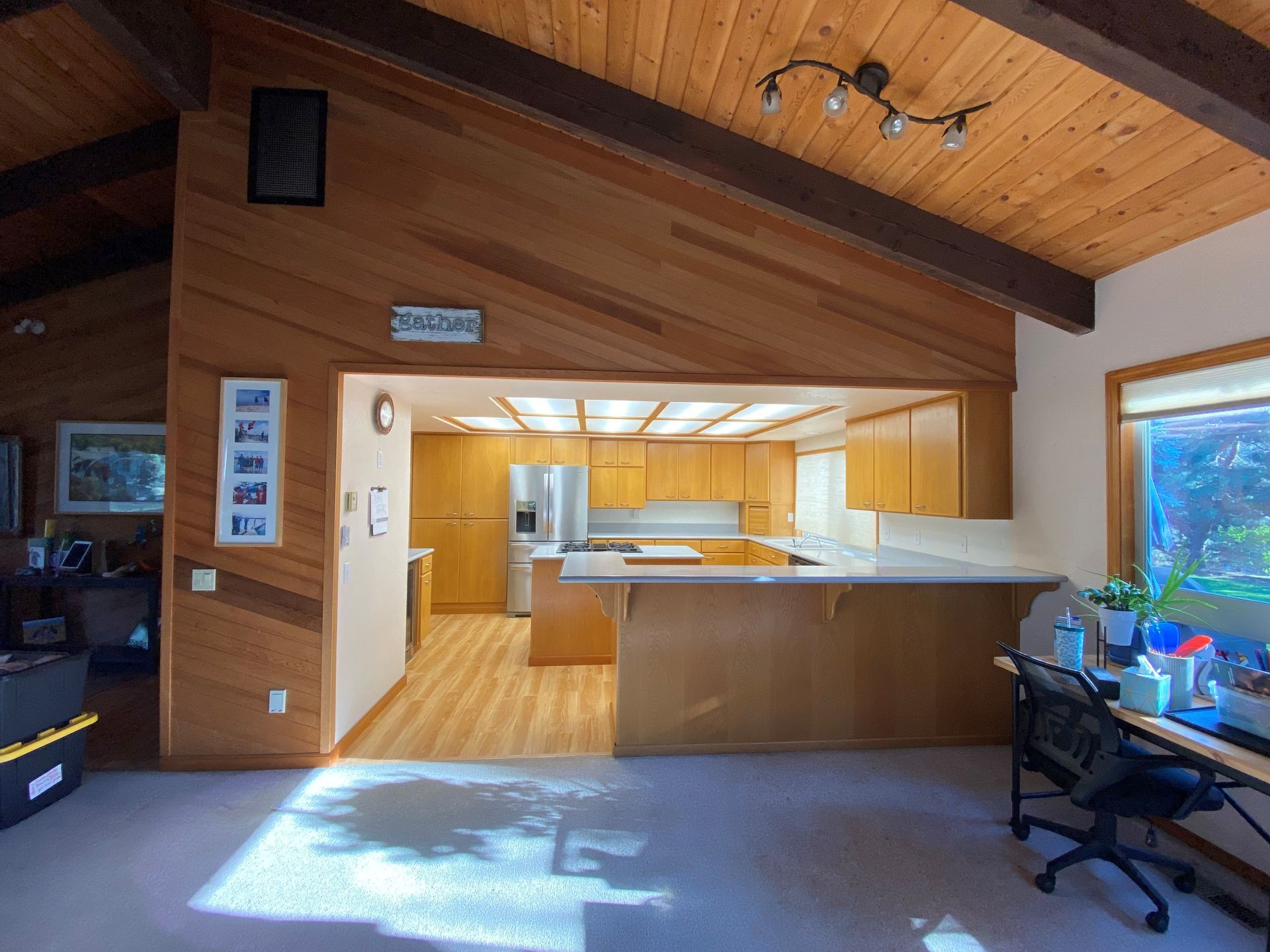 A kitchen with a sign on the ceiling that says welcome