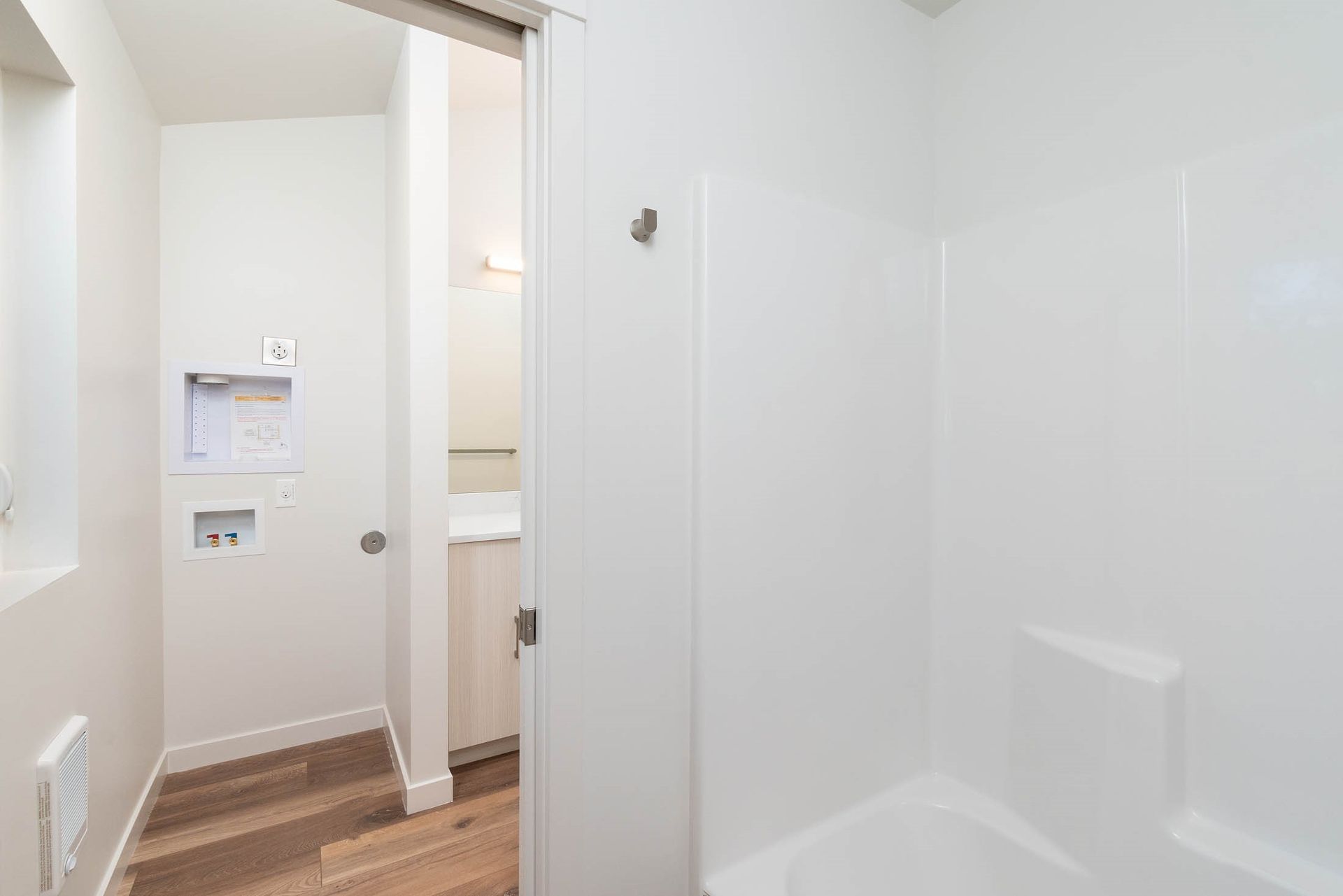 A bathroom with a sliding glass door and a bathtub.