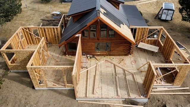 An aerial view of a log cabin under construction.