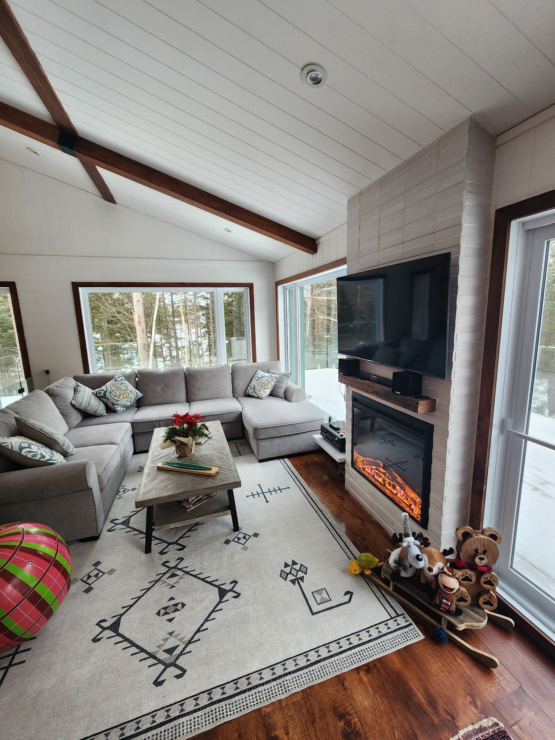 Un salon avec canapé , cheminée et télévision.