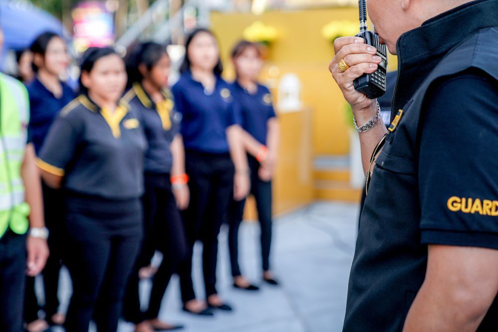 Security Guard Speaking Into Walkie Talkie - Security Company in Quirindi, NSW