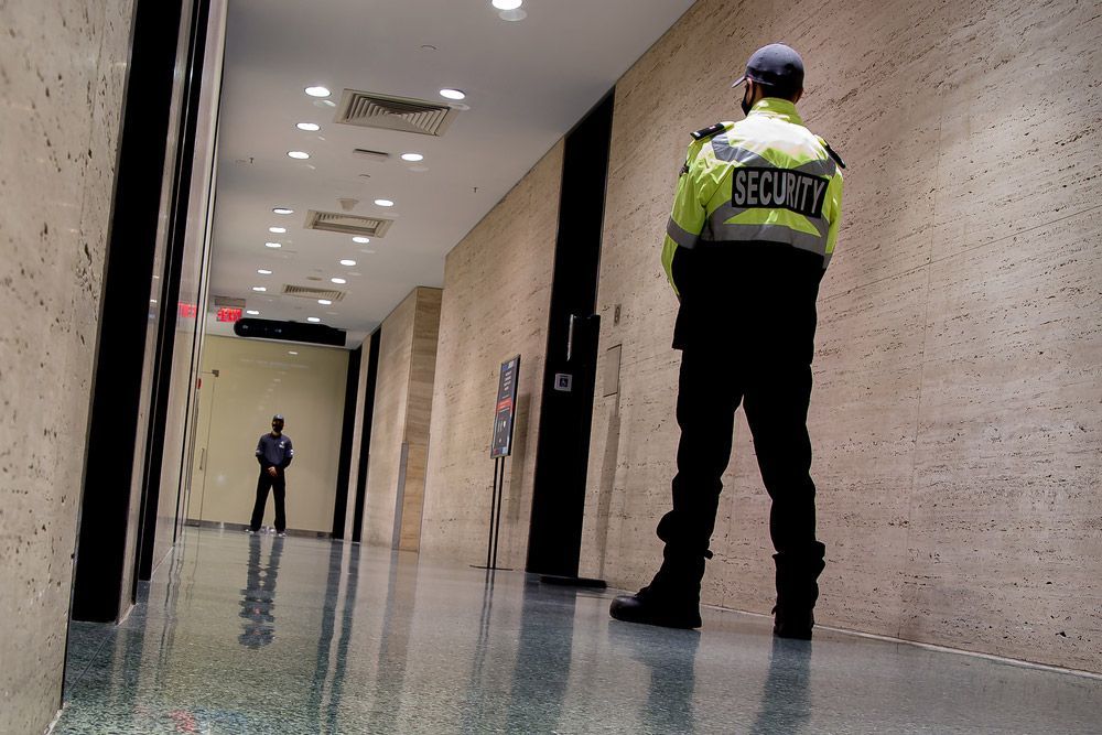 A Low-Angle Shot of Security Guards Patrolling Inside a Commercial Building - Security Company in Quirindi, NSW