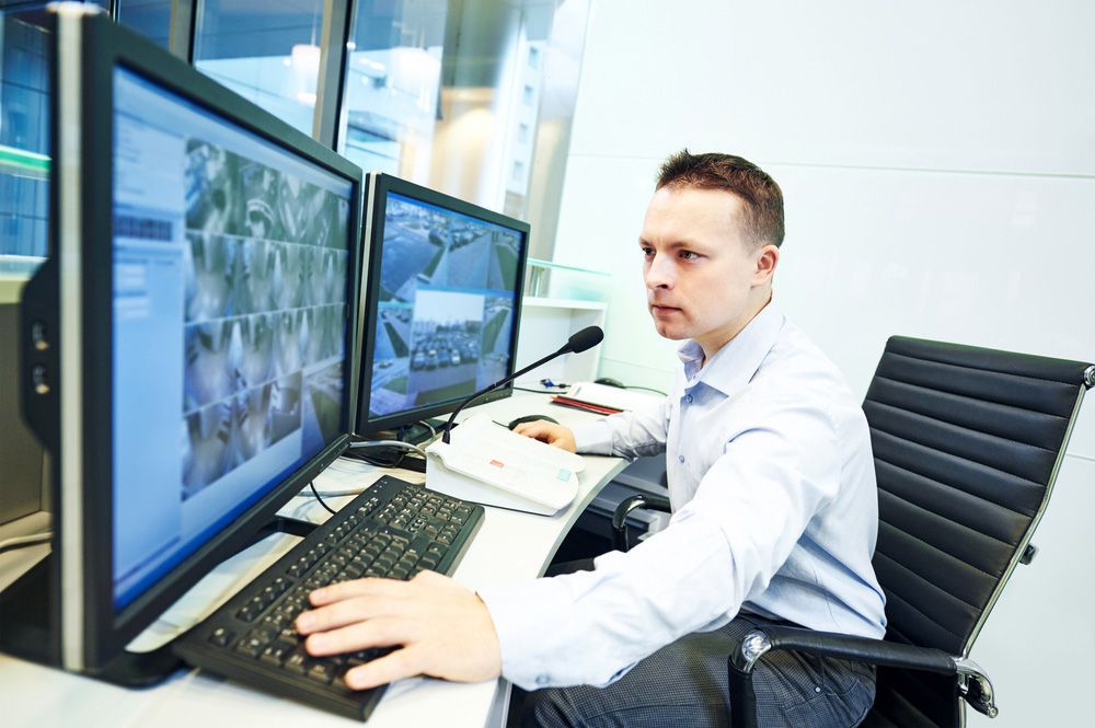 Security Guard Officer Watching Video Monitoring Surveillance Security System - Security Company in Gilgandra, NSW