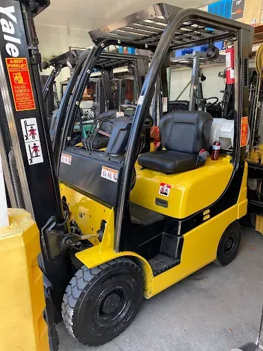 Yellow Yale forklift parked inside a warehouse.