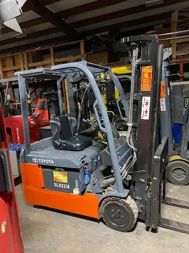 Orange and gray Toyota forklift in a warehouse.
