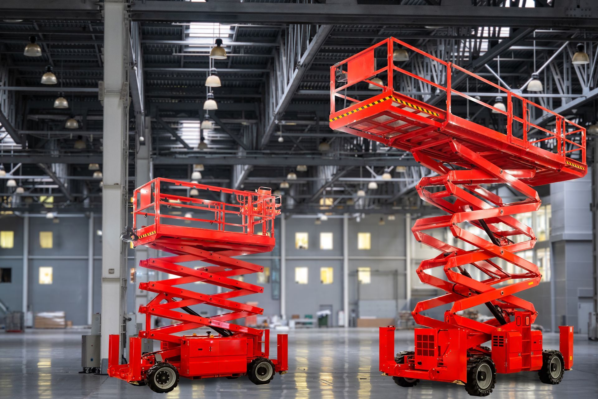 Man operating a forklift, carrying a pallet with a large cardboard box inside a warehouse.