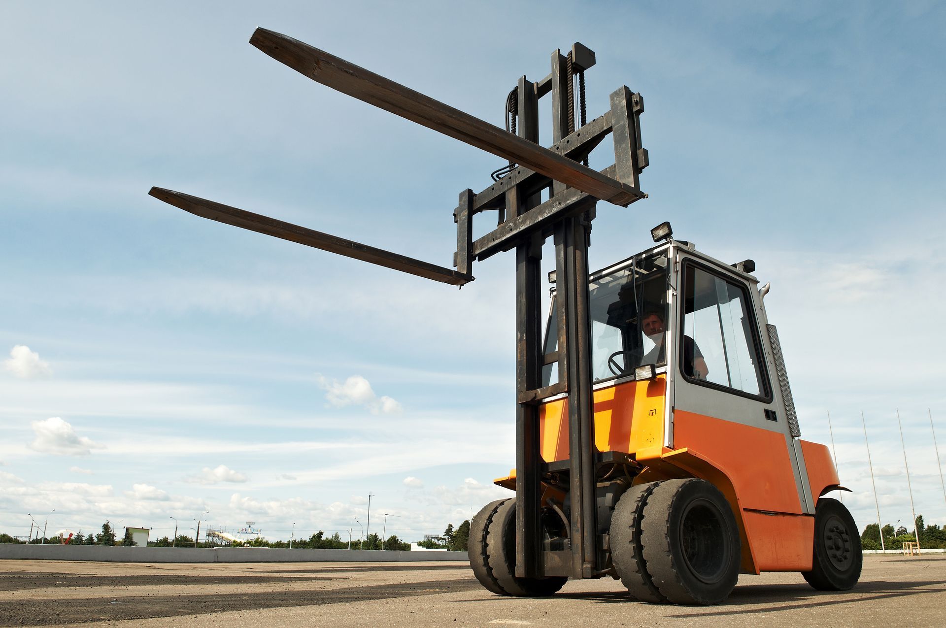 Rental forklift positioned outdoors for material handling. Rental forklift positioned outdoors for material handling.