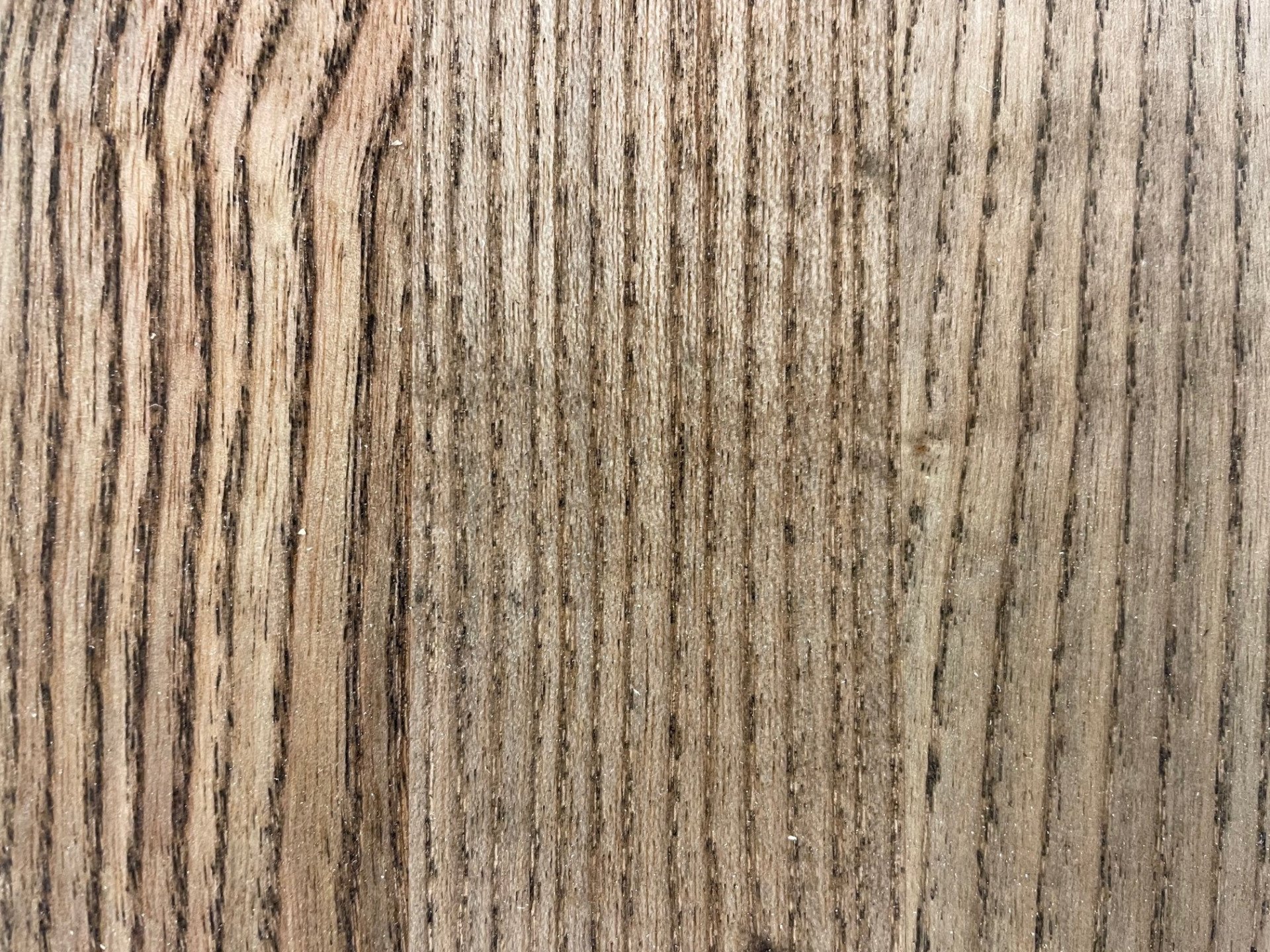 A close up of a piece of wood showing the grain and texture.