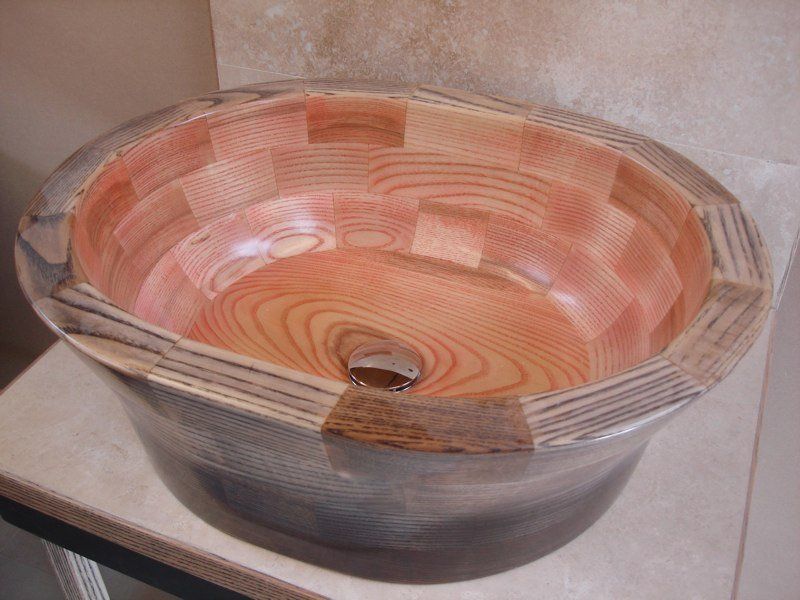 A wooden bowl is sitting on a counter top