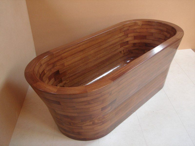 A wooden bathtub is sitting on a white surface