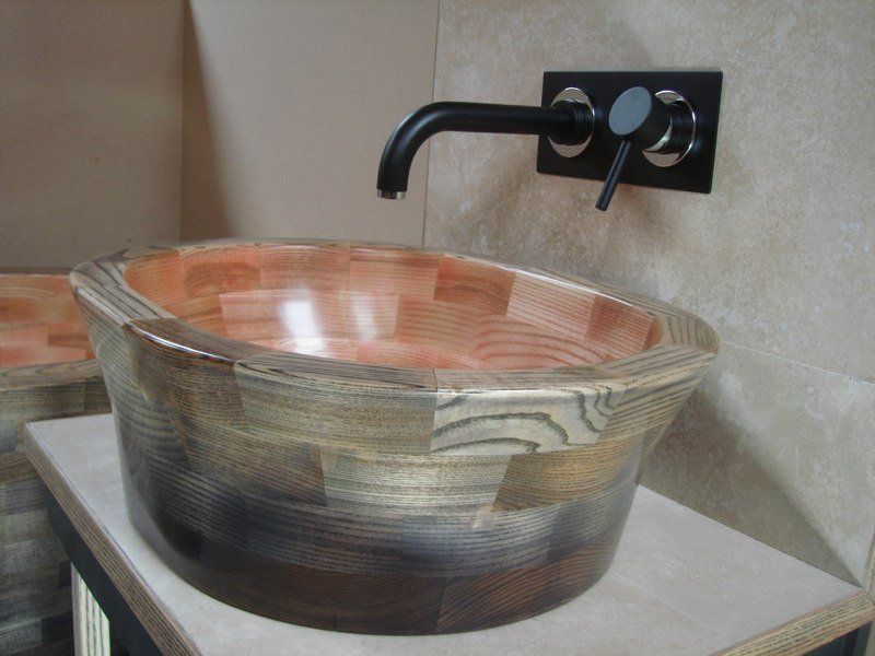 A sink in a bathroom with a black faucet