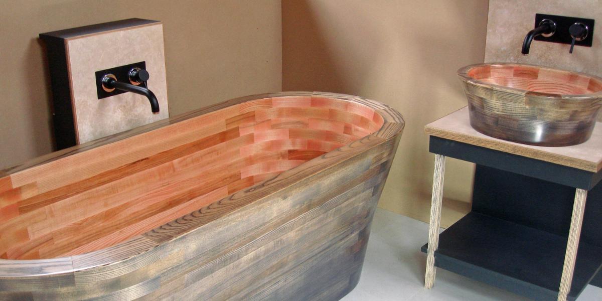 A bathroom with a wooden bathtub and a sink.