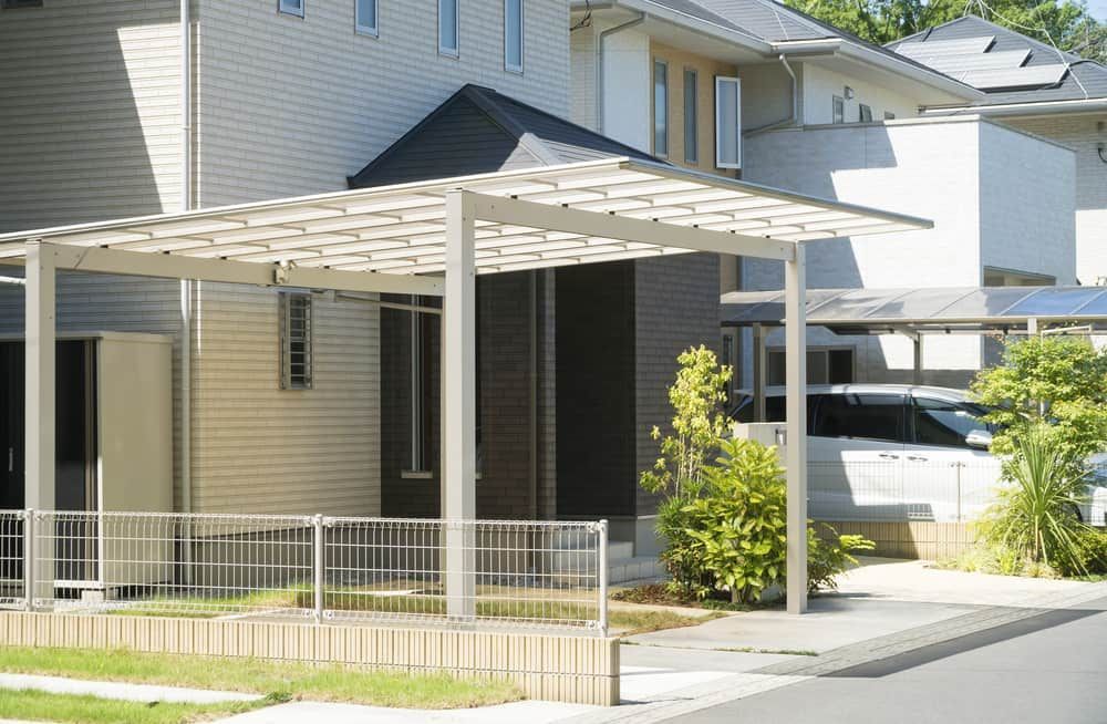 Carport in Front of a Modern Home With a Small Metal Fence — ShedBoss in Ravenshoe, QLD 
