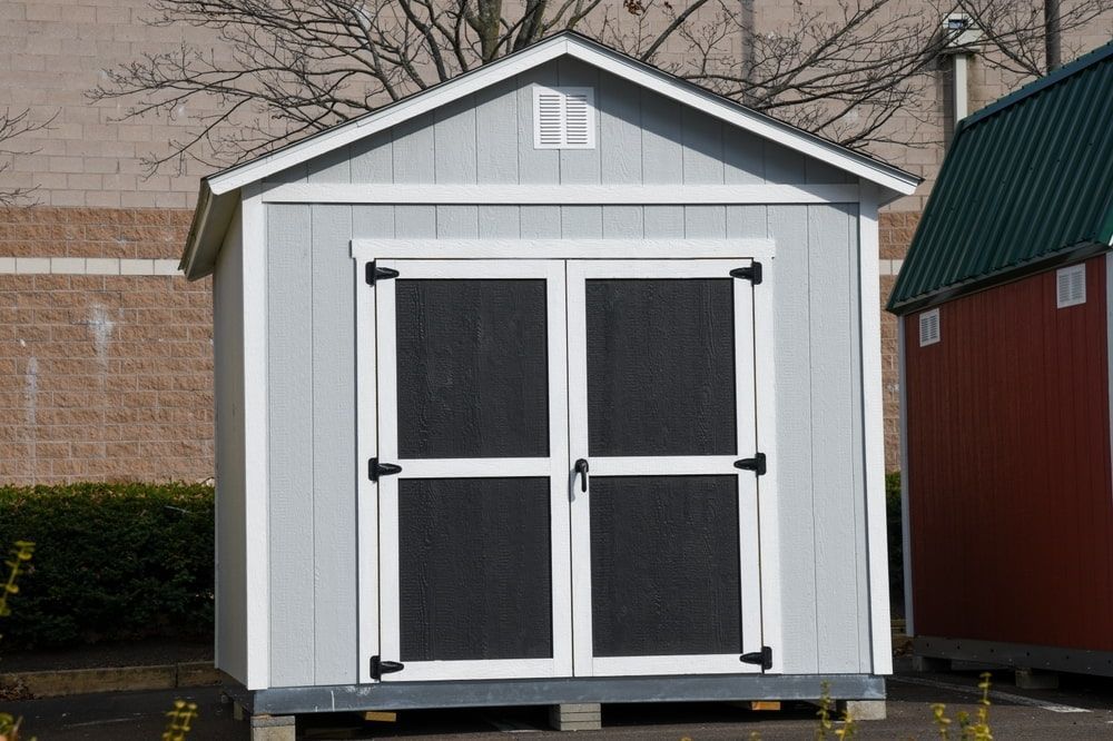 Light Blue Storage Shed With Double Doors, White Trim, and Small Vent — ShedBoss in Millaa Millaa, QLD