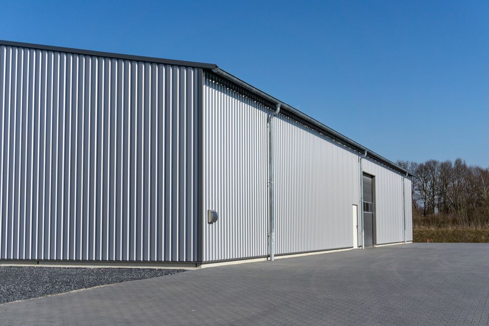 Gray Metal Warehouse With Vertical Corrugated Siding — ShedBoss in Atherton, QLD