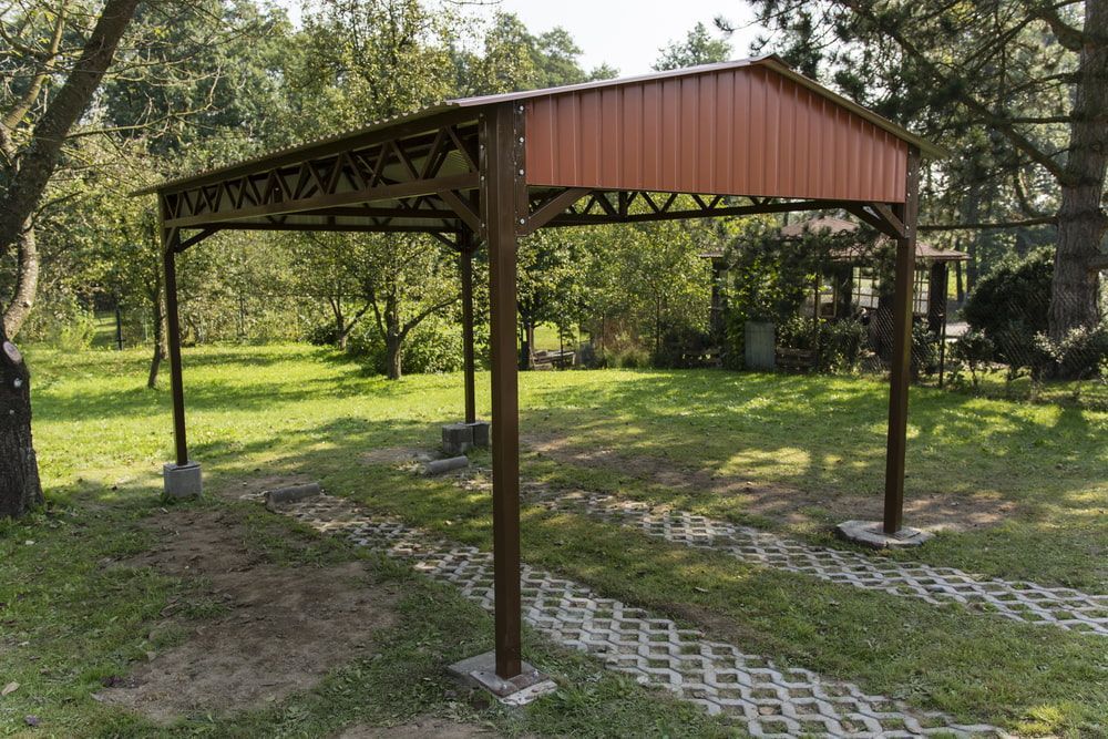 Brown Metal Carport in a Grassy Yard — ShedBoss in Millaa Millaa, QLD