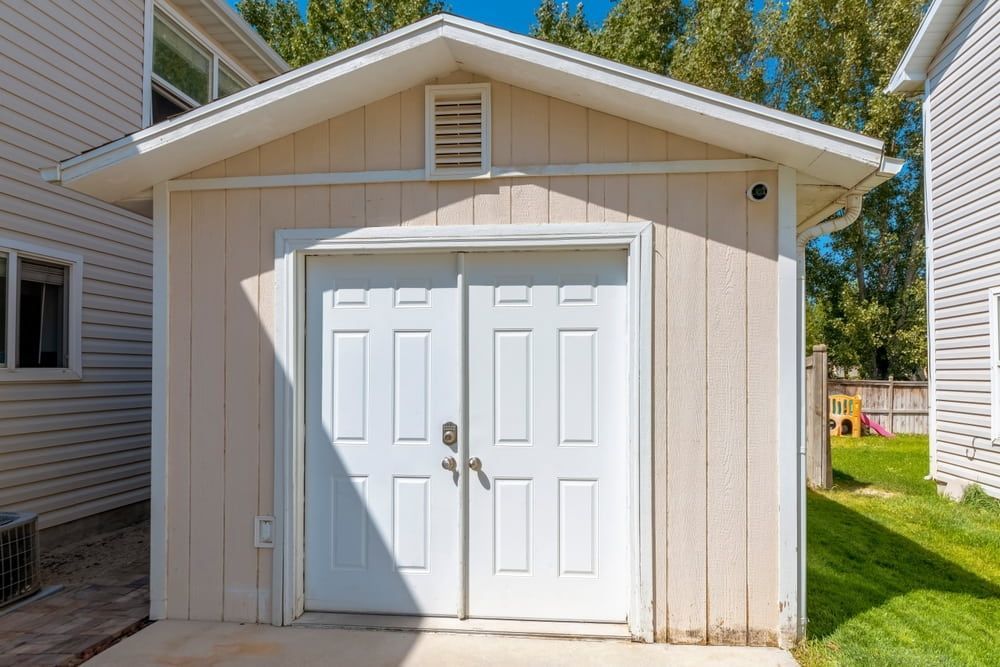 Beige Shed With White Double Doors — ShedBoss in Malanda, QLD