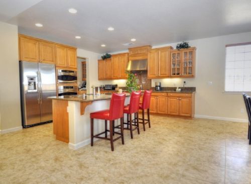 A kitchen with stainless steel appliances and wooden cabinets