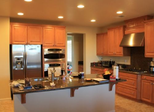 A kitchen with stainless steel appliances and wooden cabinets