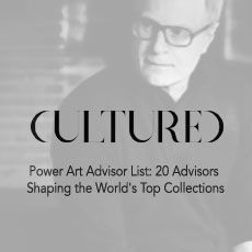 A black and white photo of a man wearing glasses.