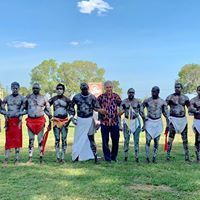 A group of men are standing next to each other in a field.