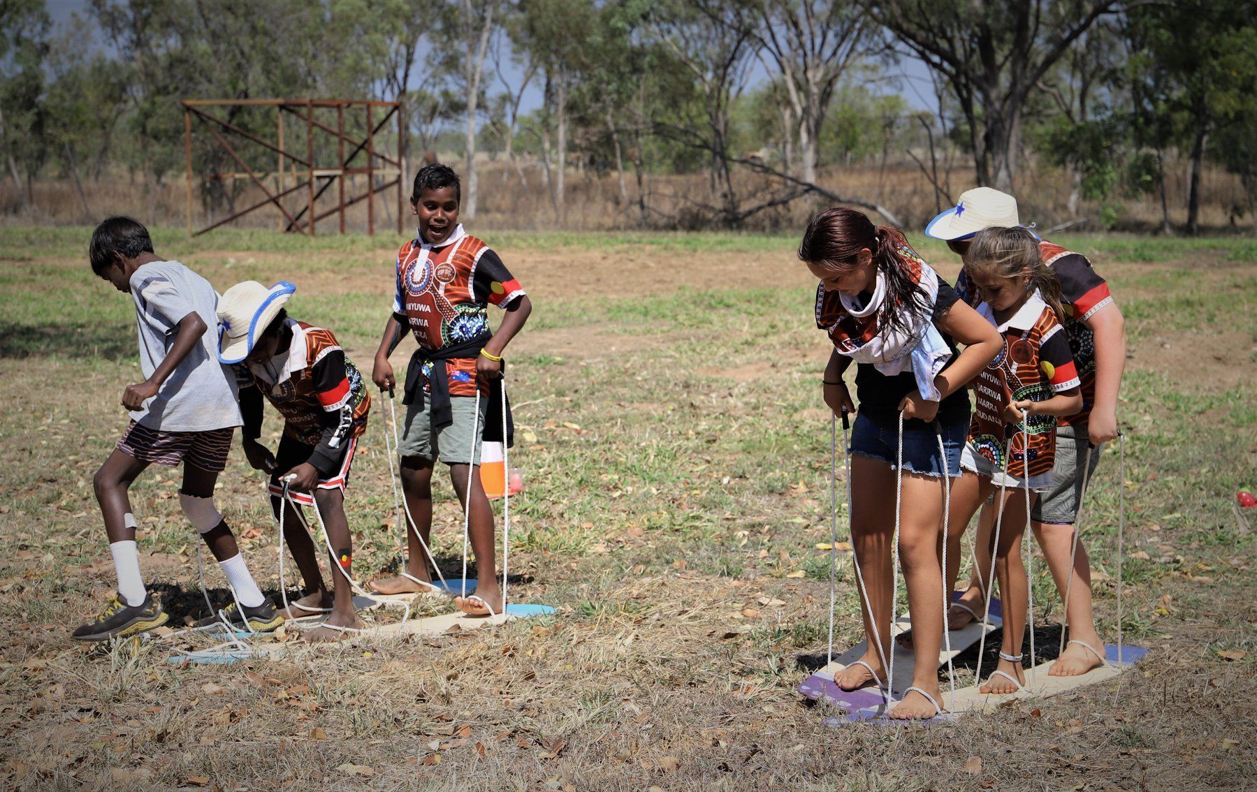 A group of children are playing a game in a field.