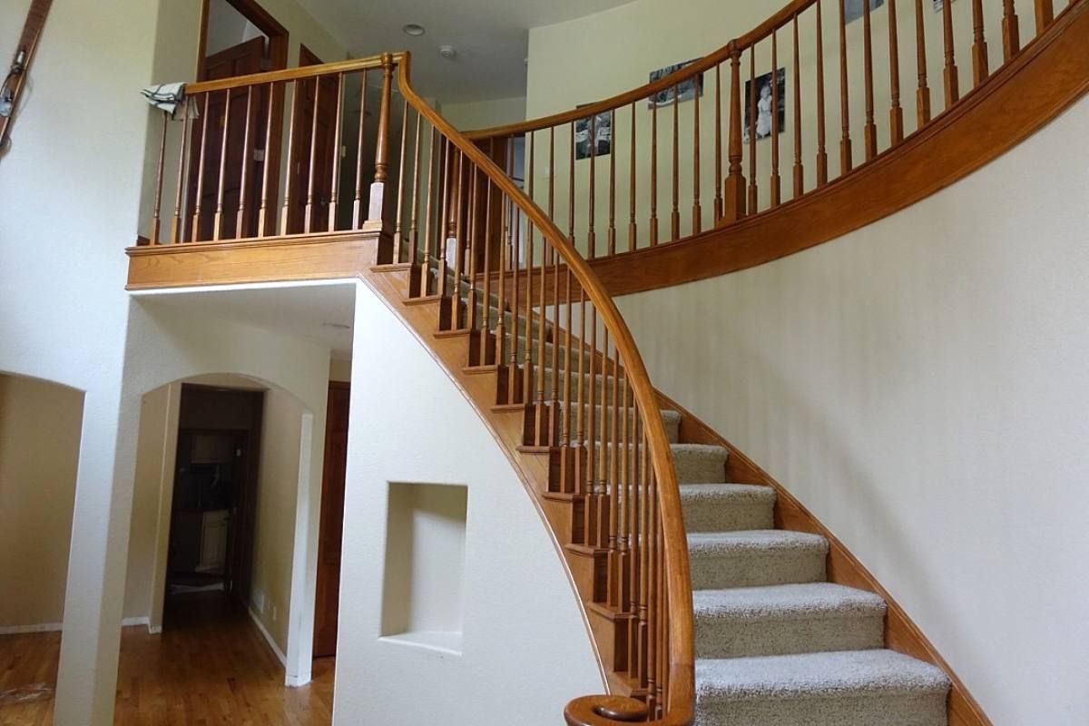 a wooden stair case in a home with wood floors