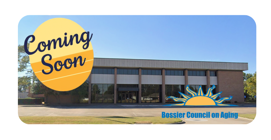 Group of volunteers in orange shirts planting in raised garden beds.