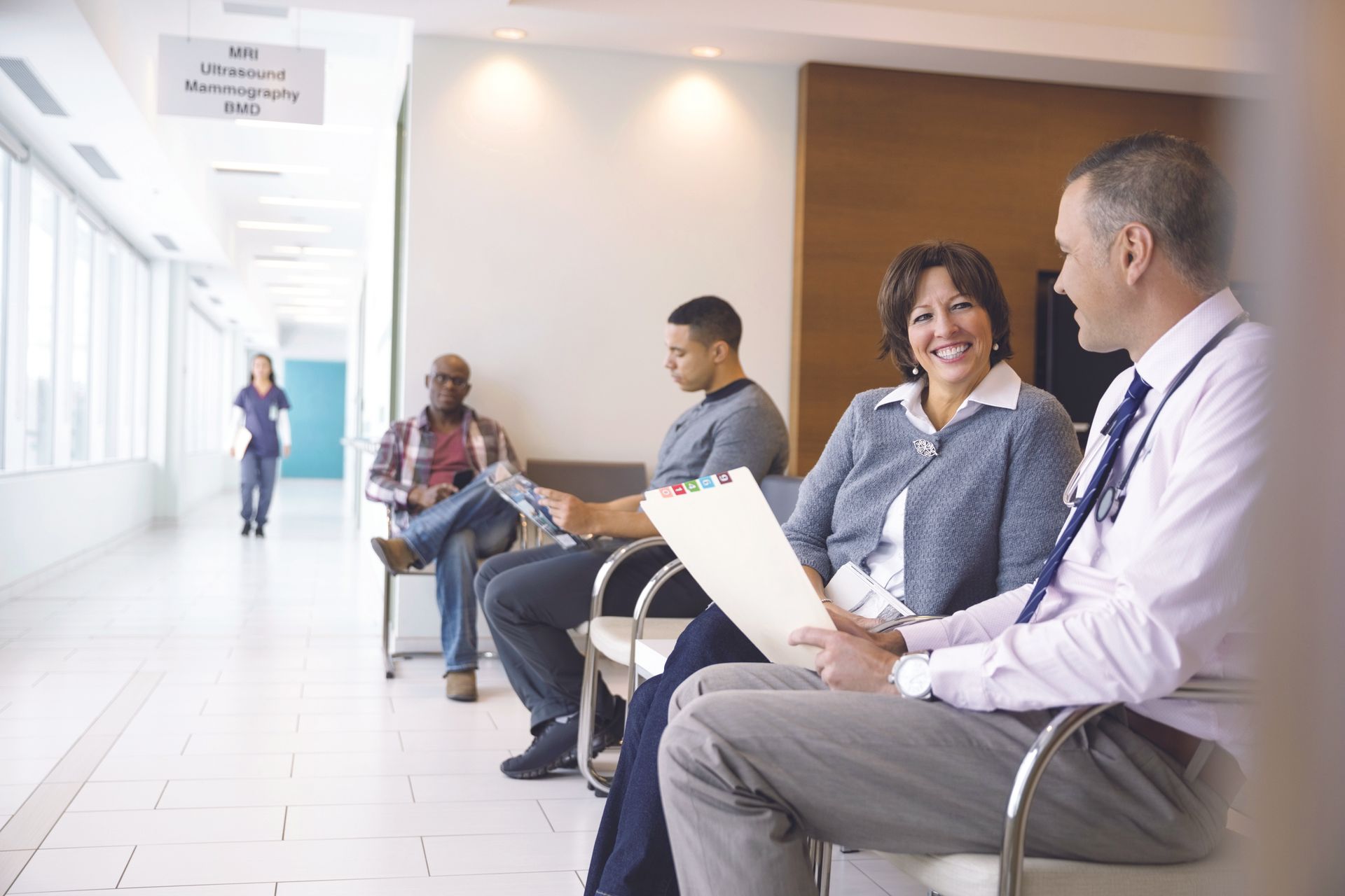 A group of people are sitting in a hospital waiting room. | You Health