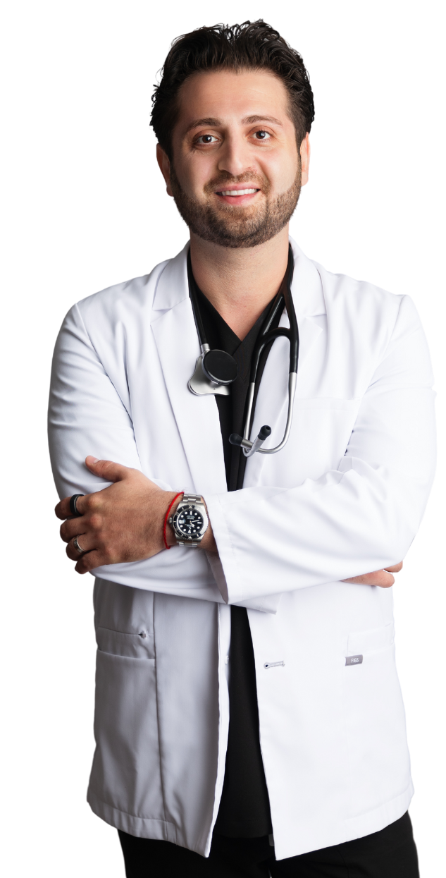 A man in a lab coat with a stethoscope around his neck is standing with his arms crossed. | You Health