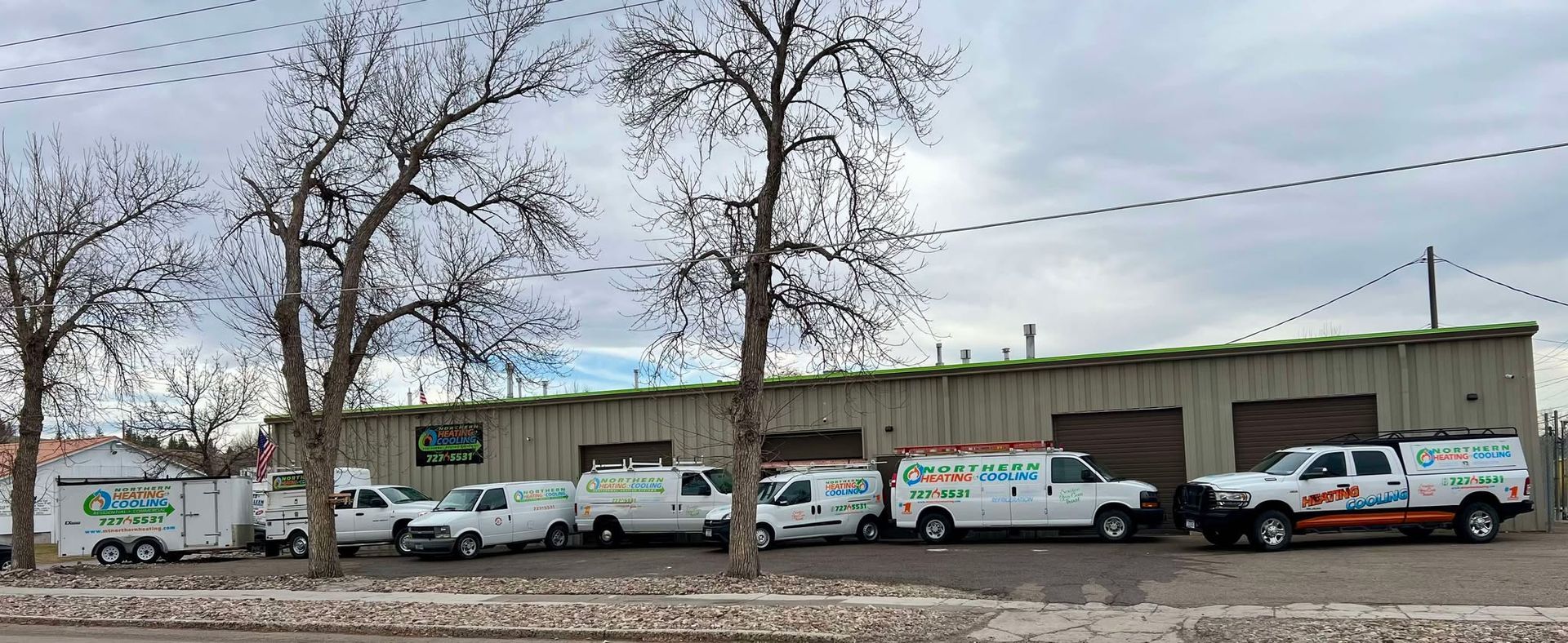 A row of vans parked in front of a building.