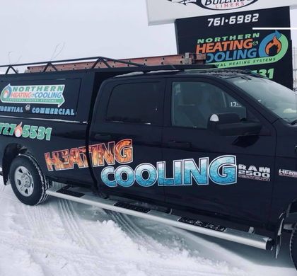 A heating cooling truck is parked in the snow
