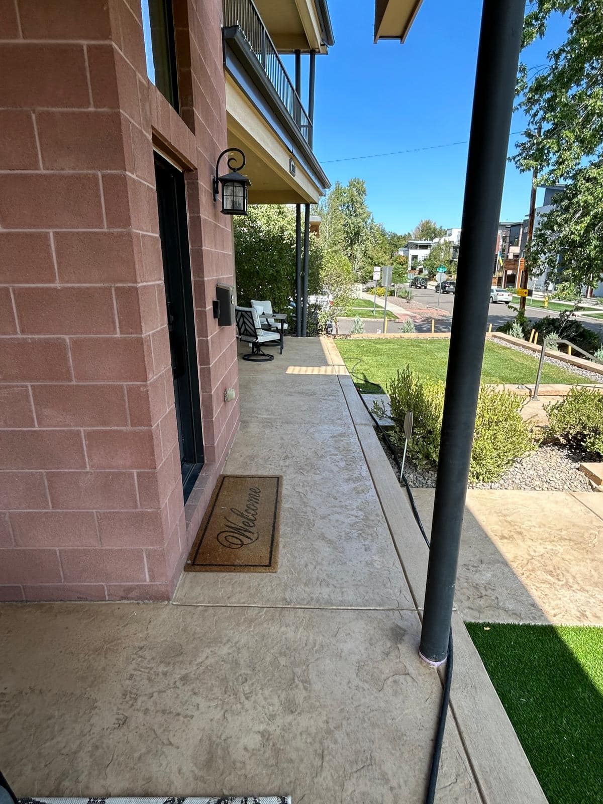 Red brick building exterior with a covered porch and 