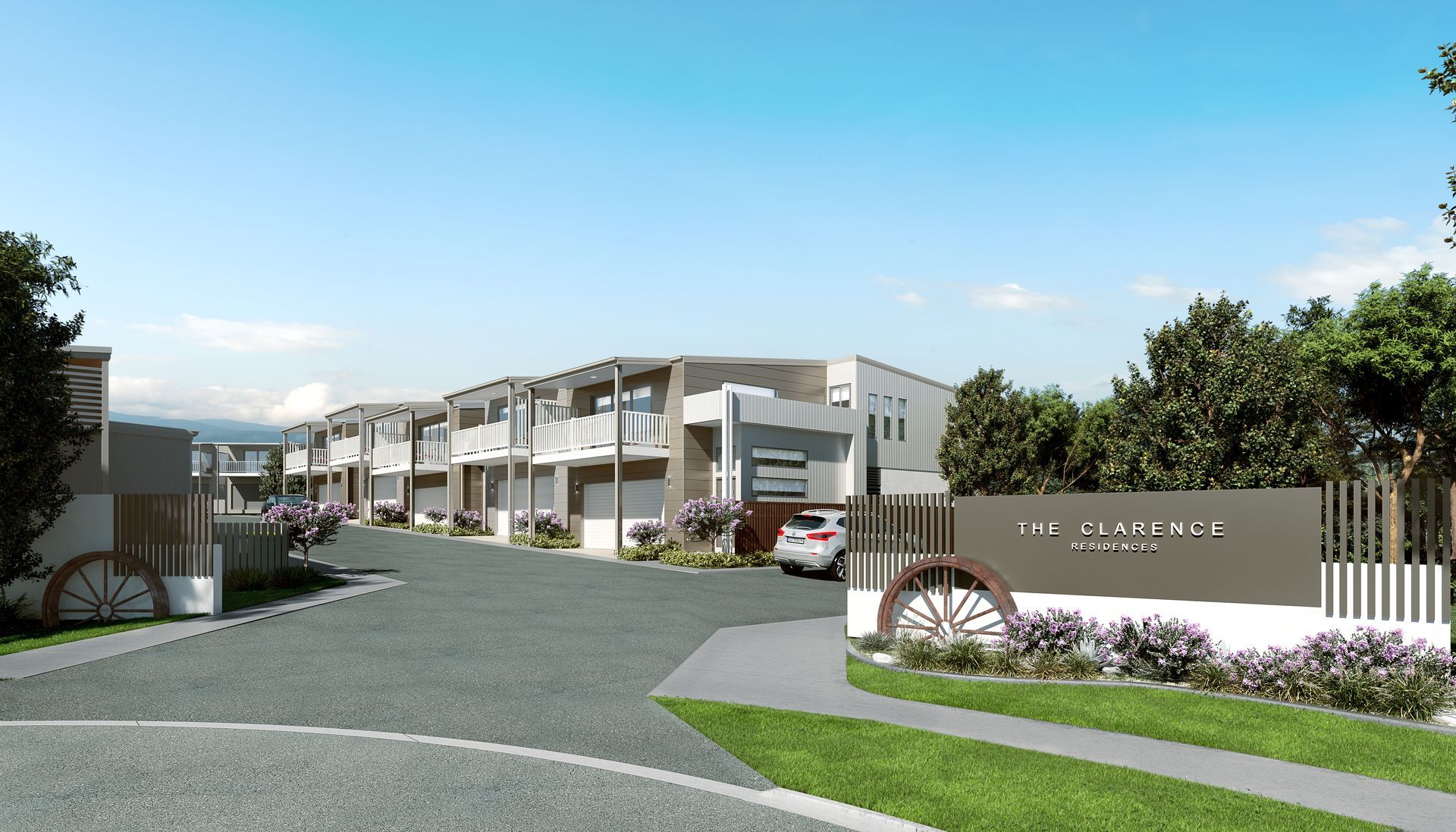 Entrance to The Lawrence Heights townhouses, with sign, vehicles, and landscaping.